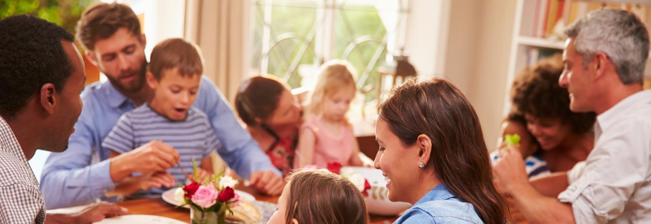 happy family eating a meal in home dining room